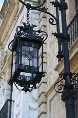 Fototapeta na wymiar Old street lamp in the Spanish street of Seville