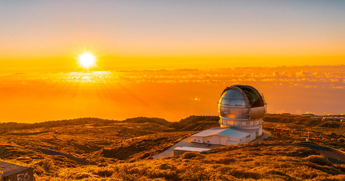 Large Canary Telescope called Grantecan optico del Roque de los Muchachos in the Caldera de Taburiente in a beautiful orange sunset, La Palma, Canary Islands. Spain