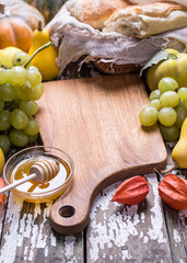 Fruit board with grape, pumpkin and sweet honey.