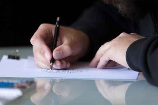 Man drawing on table