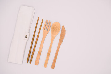 Eco friendly bamboo cutlery set isolated background. Zero waste concept. wooden travel cutlery set,...
