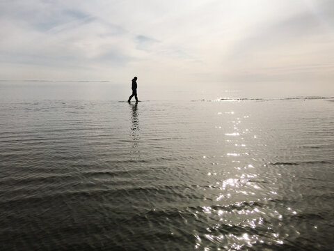 Illusion of man walking on reflective water