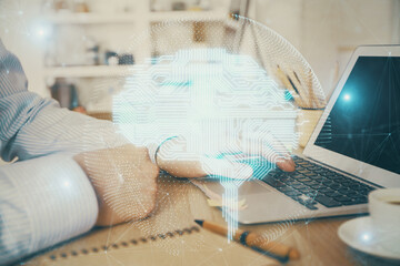 Man typing on keyboard background with brain hologram. Concept of big Data. Double exposure.