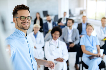Fototapeta premium Happy businessman giving a presentation to group of colleagues and doctors.
