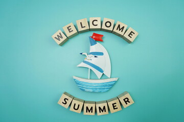 Welcome Summer message alphabet letter with sailboat on blue background