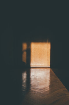 Sun shining through the window in empty dark room