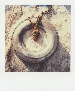 Discarded tire on beach (Polaroid SX-70 print)