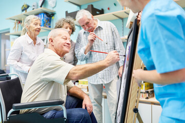 Group of seniors with dementia paints together