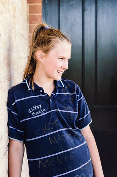 elementary or primary school girl on the last day of school, with graffiti'd sports shirt