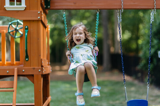Happy young girl on a swing