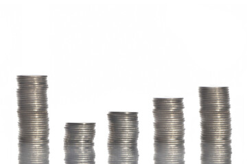 Coins layout and stack in swoosh-shaped recovery with reflection on white background, business challenge concept and emerging market idea