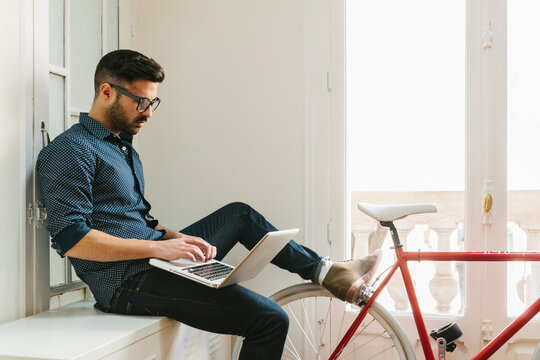 Young Man Working with a Laptop