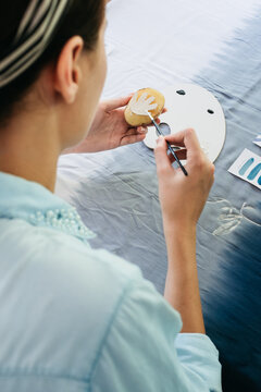 Female Artist Making Textile Print Using Potato Stamps