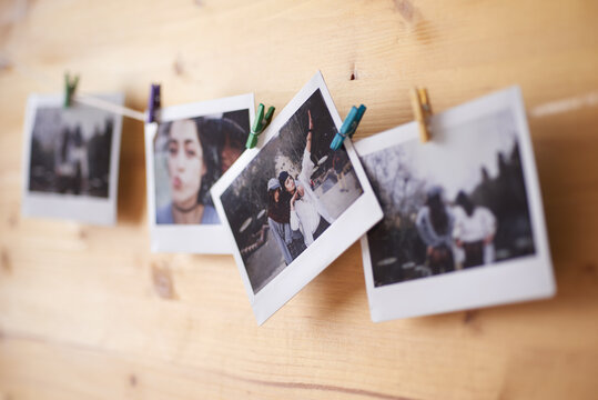 Polaroids hanging on a string