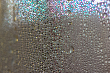 Many colorful little bubbles on the glass surface close-up