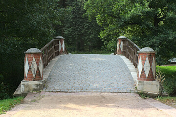 stone bridge over the river in the old park