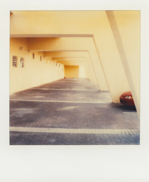 Car parked in apartment parking lot (Polaroid SX-70 print)