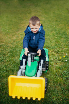 Young boy having fun with his bagger toy