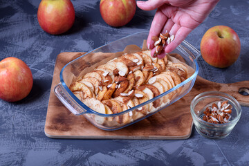 Step by step recipe for making pie with fruits and nuts. Adding almond into the glass dish with pie...
