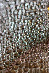 Many colorful little bubbles on the glass surface close-up