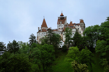 Fototapeta na wymiar El castillo de Bran comúnmente conocido fuera de Rumanía como el castillo de Drácula en un día nublado. Bran, Rumanía.