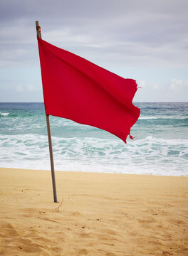 Red flag on sandy beach