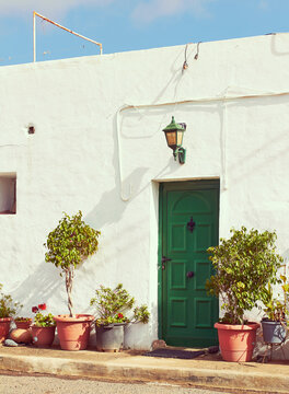 Old spanish home with green door and plants