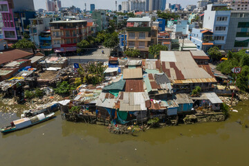 Old shacks made from Corrugated iron in contrast with modern buildings along the waterfront of Kenh...
