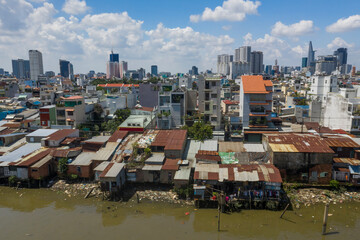 view of the city with waterfront corrugated iron shacks in the foreground along the Kenh Te canal