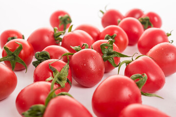 Red small tomatoes on white background