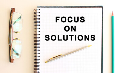 Notepad with text on a white background, near glasses and pencil. Business concept.