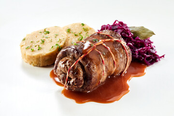 Serving of a single beef roulade with red cabbage