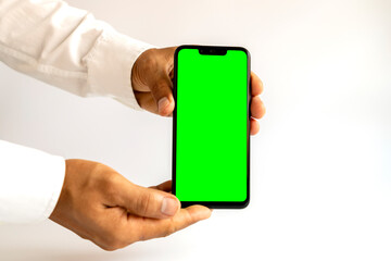 hand holding smartphone with green screen
