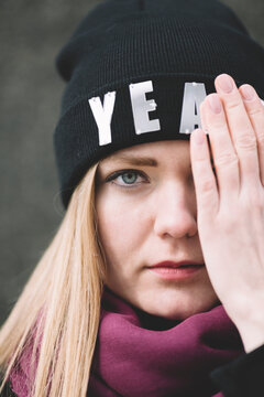 woman with eye covered by hand, selective focus on eye