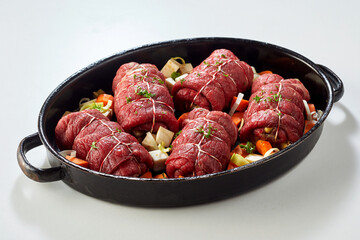 Baking pan with uncooked beef roulades