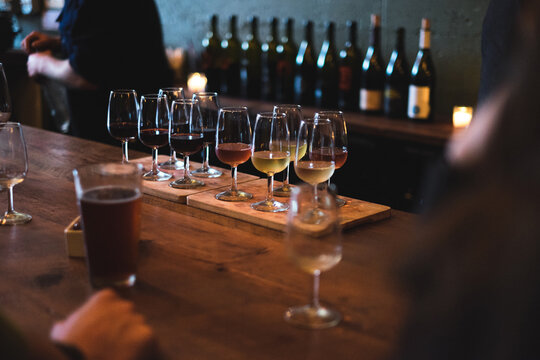 Sampler tray of wine sitting on bar at winery