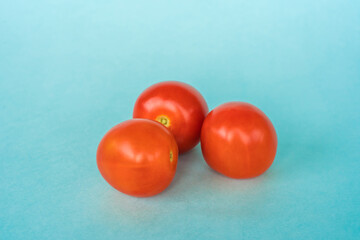 Fototapeta na wymiar Group of fresh tomato on blue background