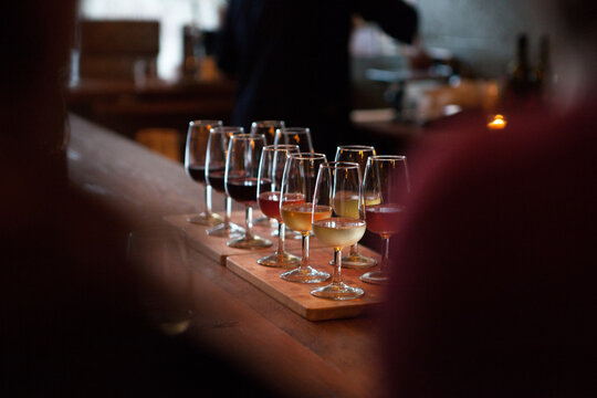 Sampler tray of wine sitting on bar at winery