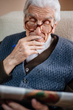 Portrait of senior man reading newspapers