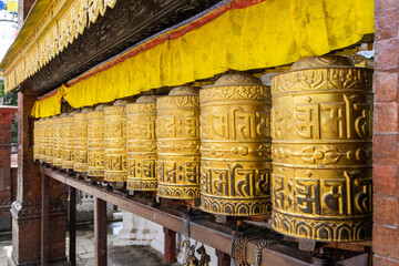 Picture of buddhist prayer wheels in a row