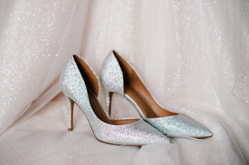 Stylish silver shoes, are isolated standing on white background. Wedding accessory bride.