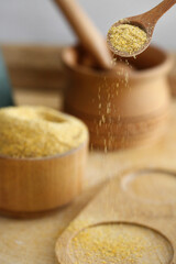 ground mustard in a wooden spoon on the table