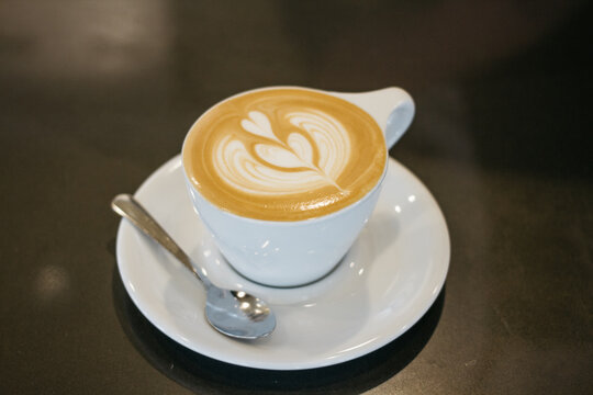 pouring latte cappuccino coffee, in cafe