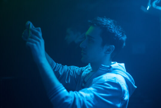 Man taking a photograph with his phone in the night club
