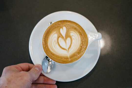 pouring latte cappuccino coffee, in cafe