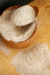 Fototapeta na wymiar almond flour in bowl on wooden surface