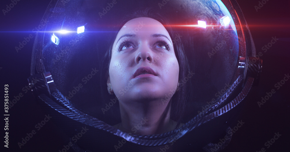 Wall mural young fearless beautiful female astronaut exploring the infinite space. she is exploring outer space