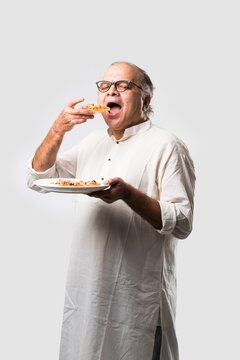 Asian Indian Old Man Eating Pizza With Funny Expressions