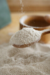 Spoon of sesame flour isolated on white, top view