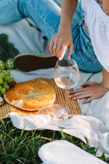 Girl with a glass sitting on a picnic